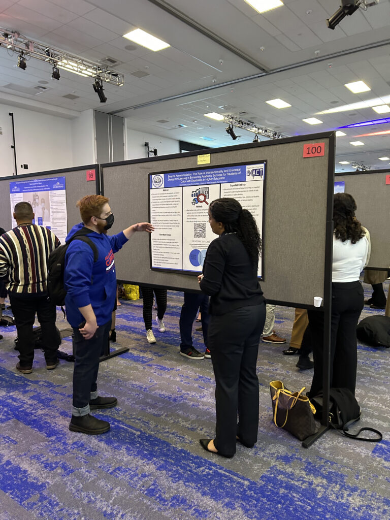 Photo of Mishon at Meeting of the Minds 2023, presenting her poster.