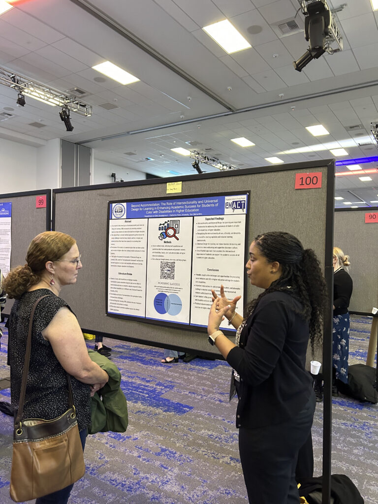 Photo of Mishon at Meeting of the Minds 2023, presenting her poster.