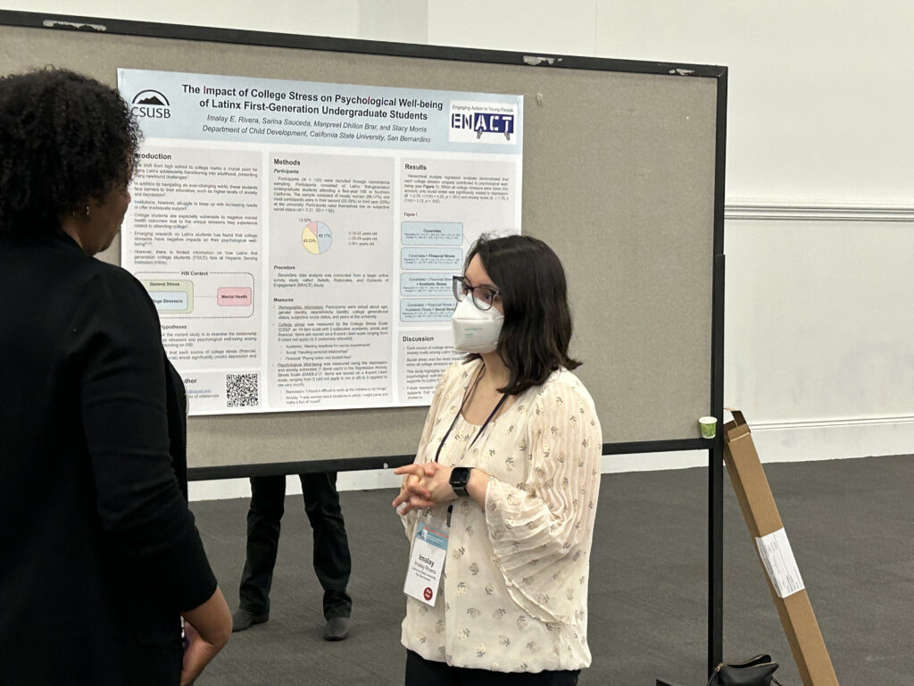 Photo of Imalay at SRA 2023, presenting her poster.